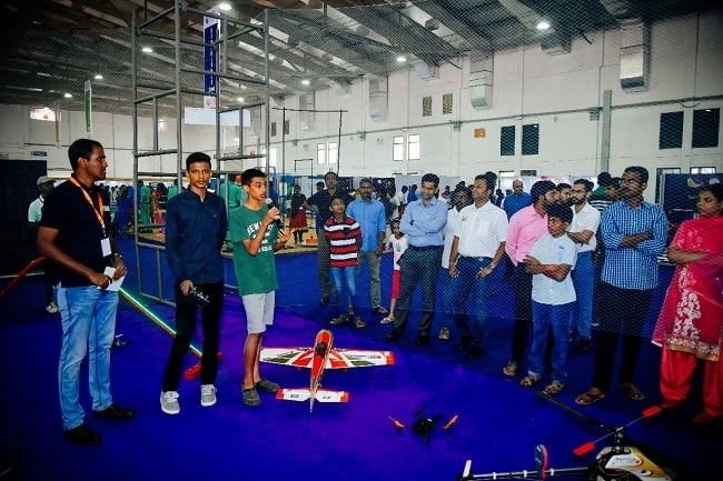 Visitors watching model aircraft demonstrations at the science exhibition.