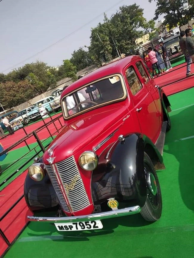 A red vintage car displayed at the Coimbatore Vizha car exhibition.