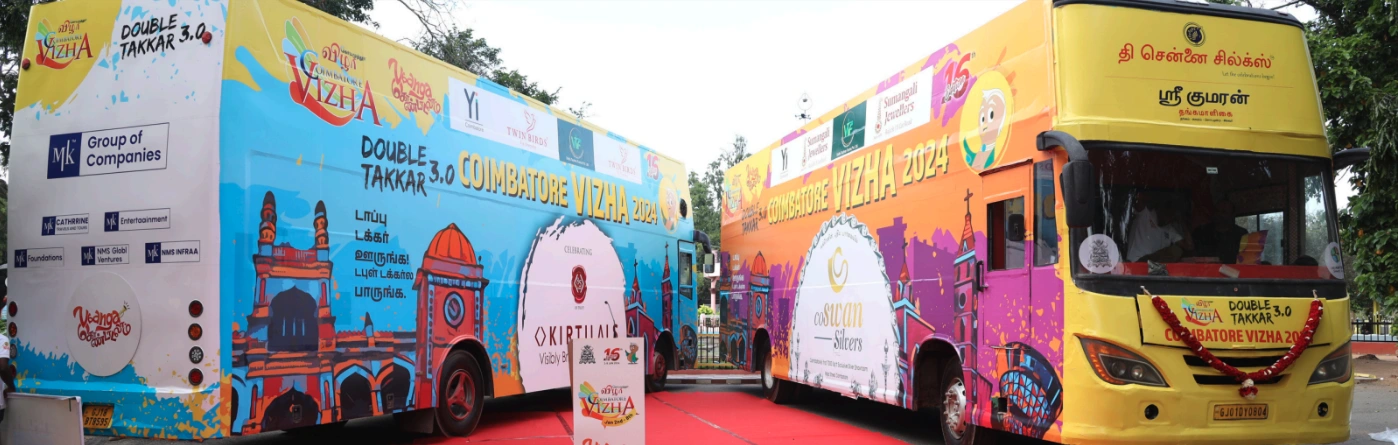 Two colourfully decorated Coimbatore Vizha double-decker buses